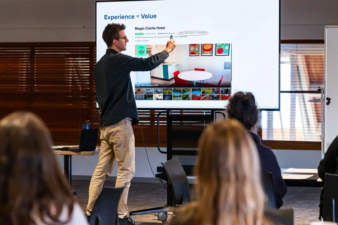 Brad leading a co-design workshop in front of a screen